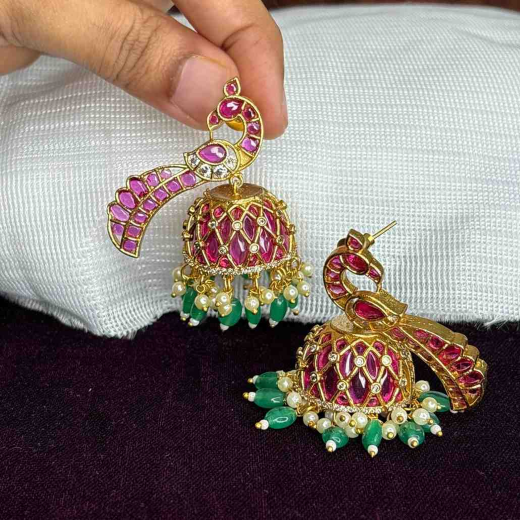 Matte finishing peacock-inspired pink Gemstones and pearl drops Jhumka’s